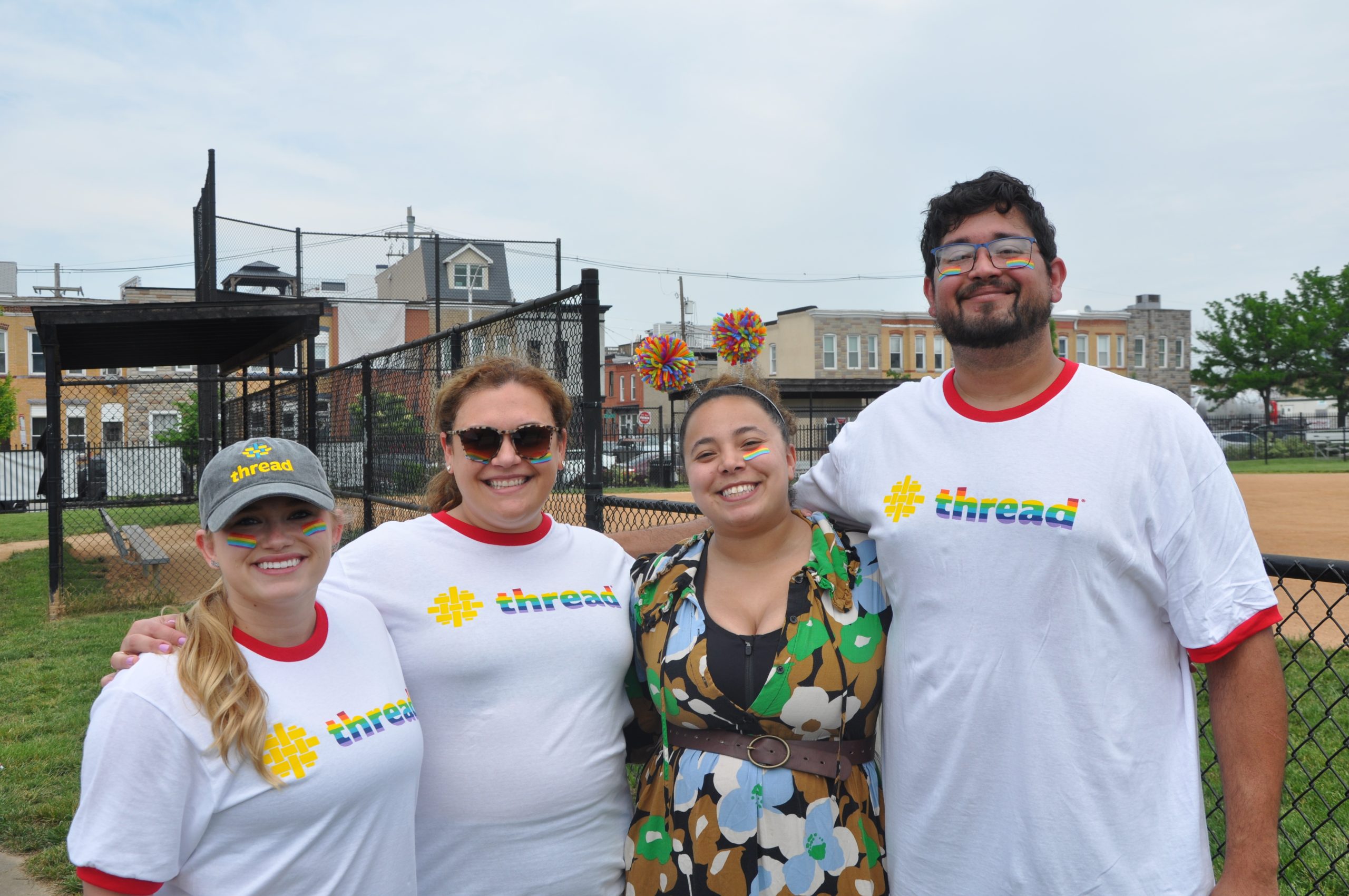 Thread staff members posing together in Thread branded pride shirts at a kickball game