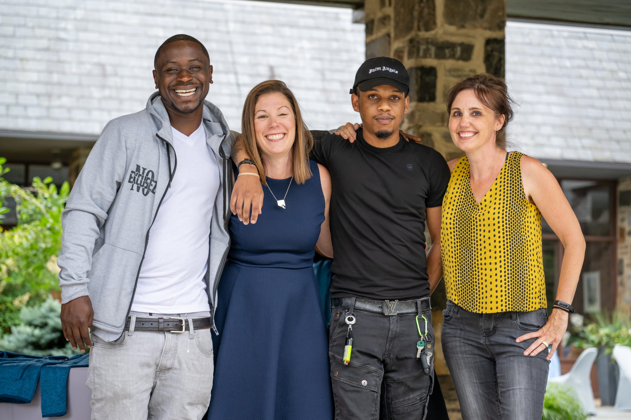 Thread CEO Sarah Hemminger posing with two Thread alumni and a volunteer.