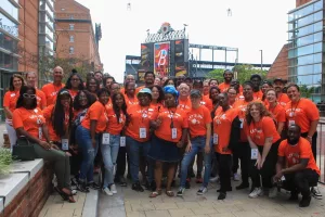 Thread Staff posing in front of Camden Yards wearing Orioles themed shirts.